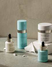 Image of MATTER OF FACT skincare products on a stone beige background.